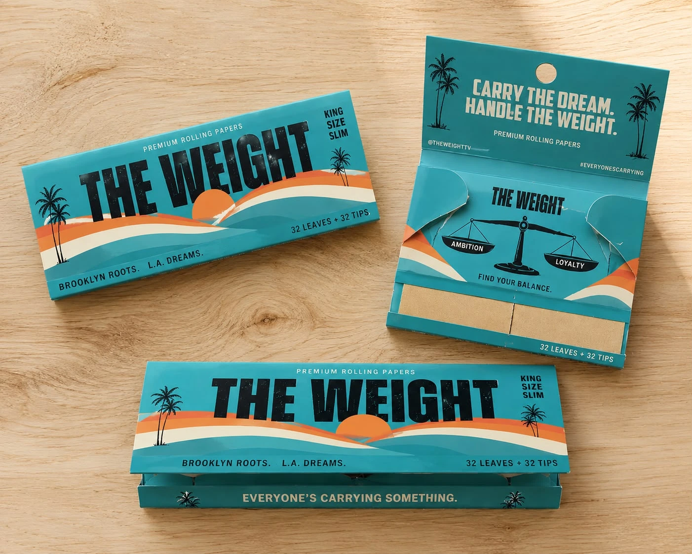 THE WEIGHT rolling-paper packaging in turquoise, sunset orange and cream, shown open and closed